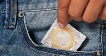 A man takes a condom out of his pocket.