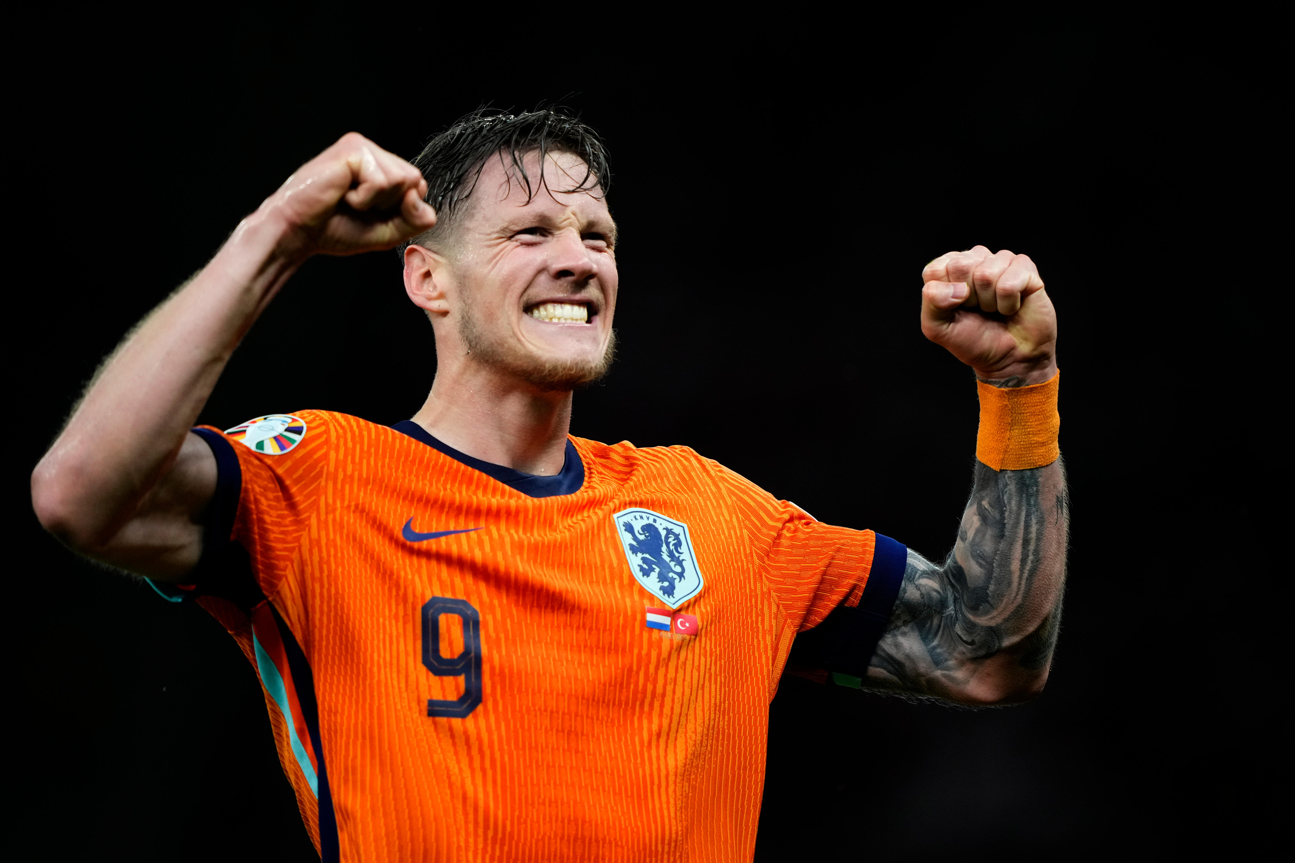 Wout Weghorst smiles and holds up his arms