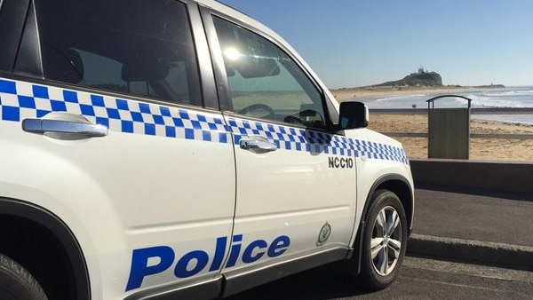 Police establish a crime scene on Nobbys Beach