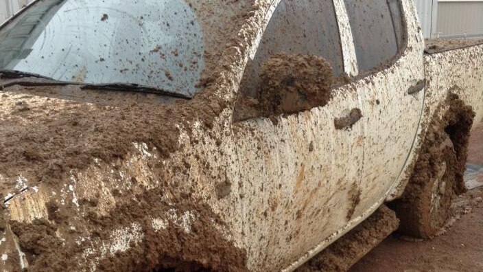 A ute covered in mud in western Queensland.