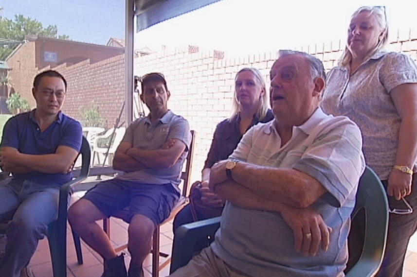 Homeowner Bill Elliott sits with other residents whose properties are being acquired for WestConnex.