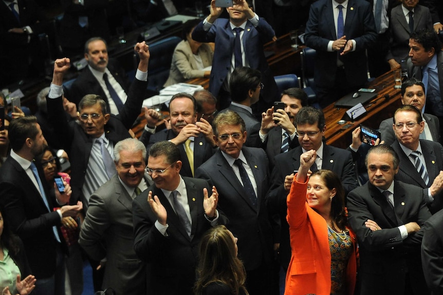 Brazilian senators celebrate the removal of Dilma Rousseff from office.