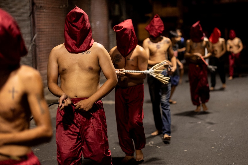 Filipino Catholics with no shirt and hoodies on.