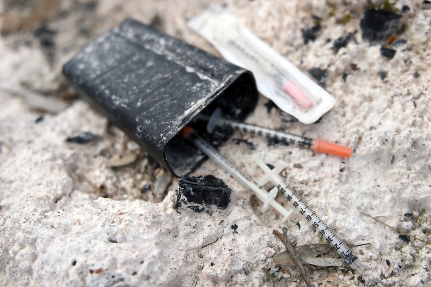 used syringes thrown on the ground