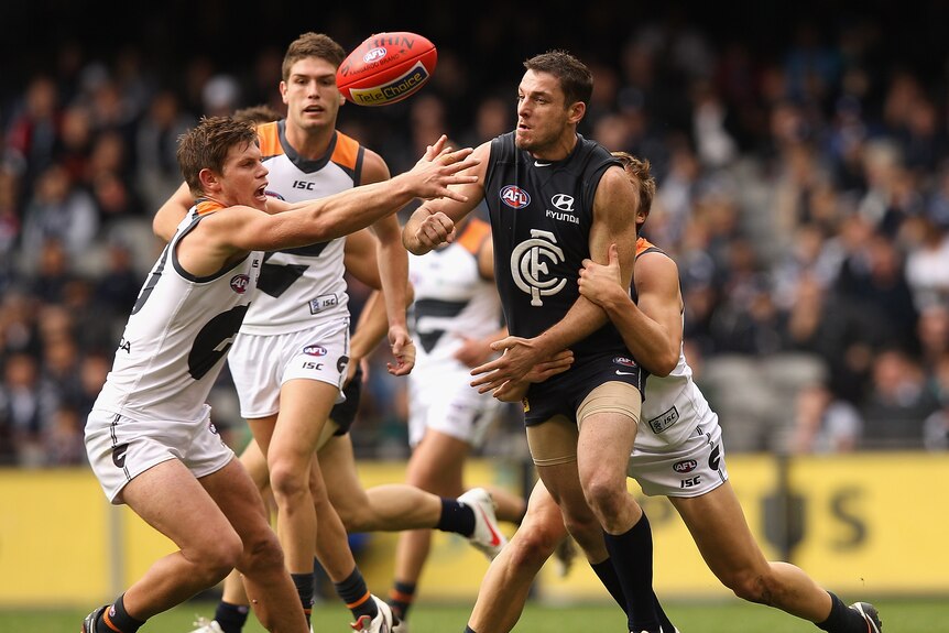 Carlton's Heath Scotland handballs against GWS at Docklands in May 2012.