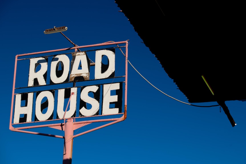 A road house sign at dusk