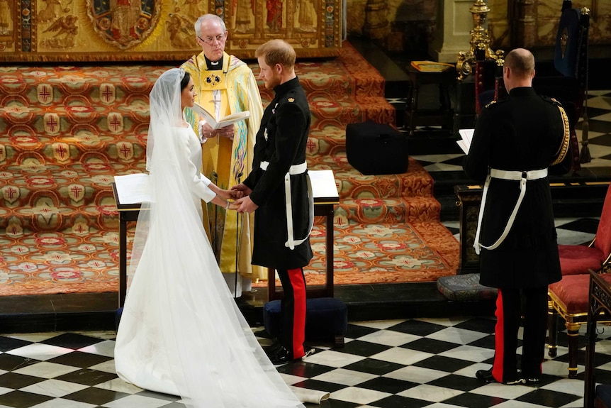 Britain's Prince Harry and Meghan Markle hold hands.