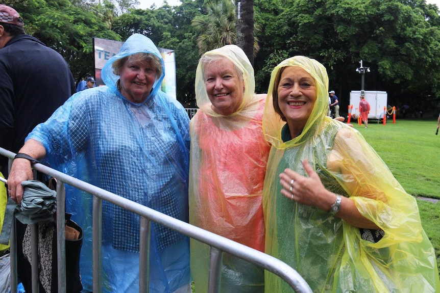 Women wear colourful poncho raincoats at Brisbane's City Botanic Gardens
