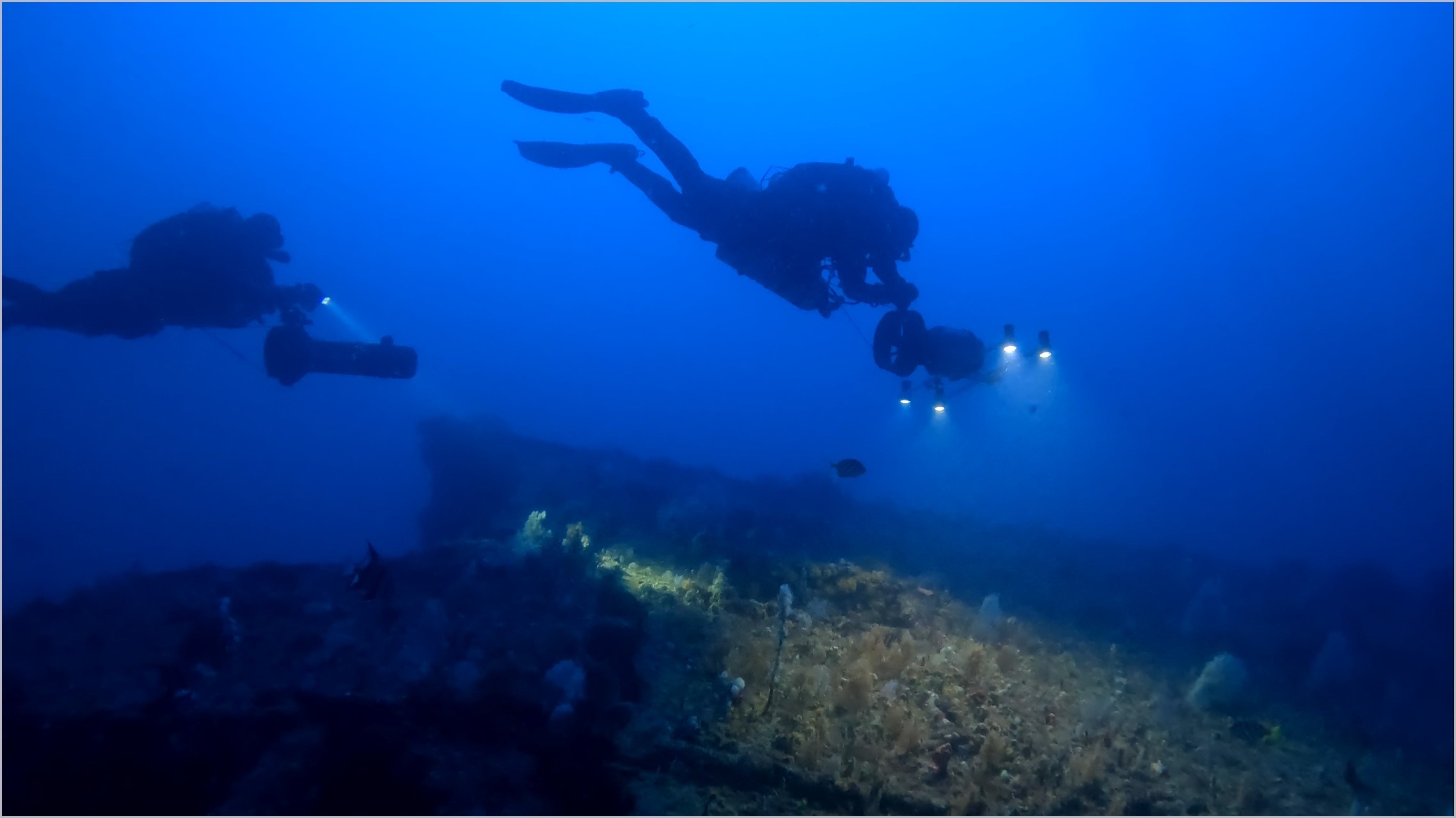 Two scuba divers deep underwater