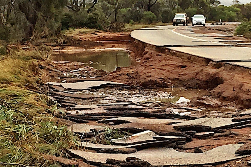 Road rubble piled up next to a flood-damaged stretch of highway near Jerdacuttup, Western Australia.