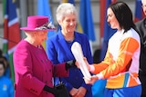 Anna Meares (R), receives Commonwealth Games relay baton from the Queen (L), on March 13, 2017.