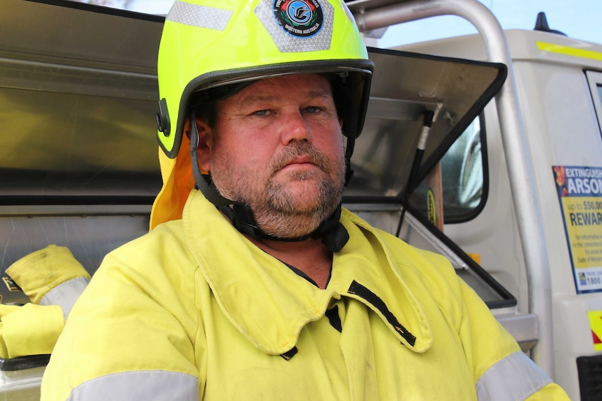 A headshot of a man in firefighting gear.