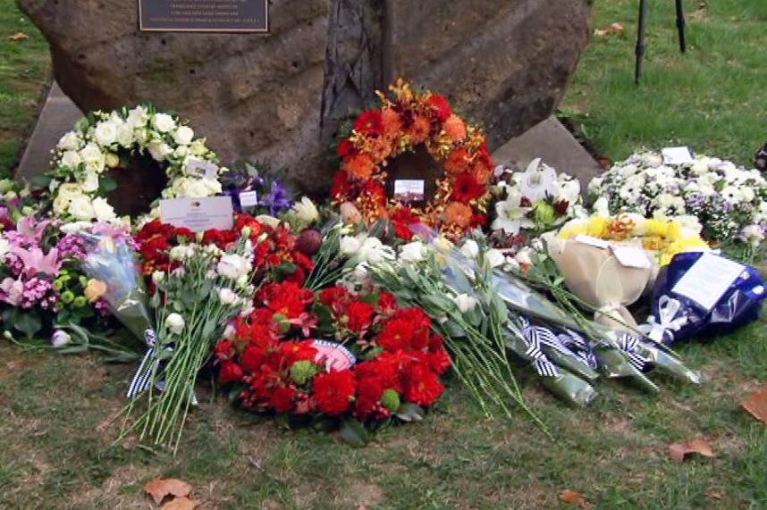 Wreaths of flowers laid at a memorial service in Melbourne to workers killed on the job.