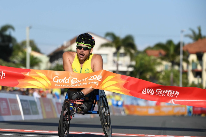 Kurt Fearnley crosses the finish line at the Commonwealth Games on the Gold Coast.