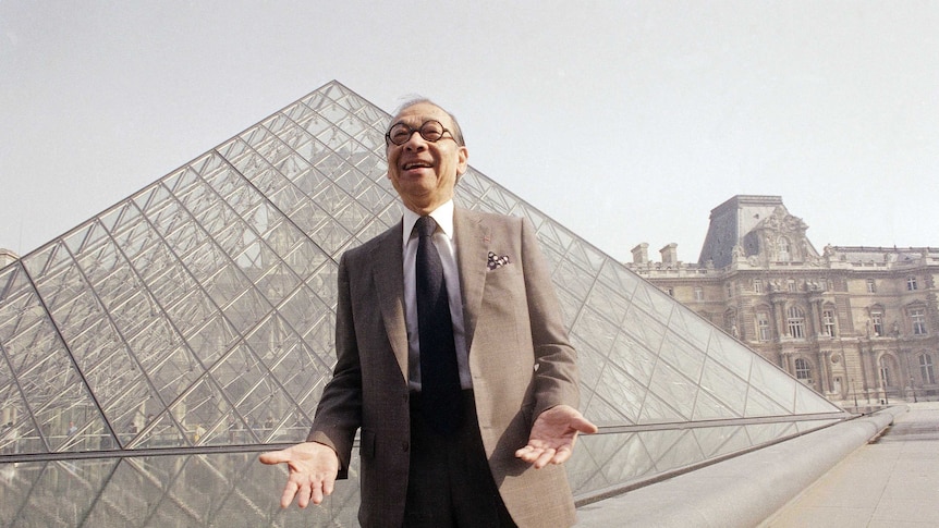 I.M Pei laughs while posing for a portrat in in front of the Lourve glass pyramid in the museum's Napoleon Courtyard.
