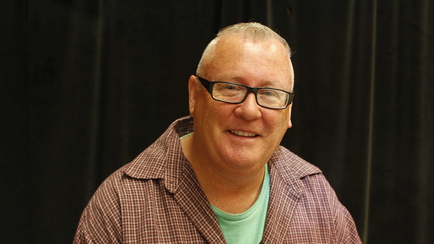 Man wearing a checked shirt and glasses