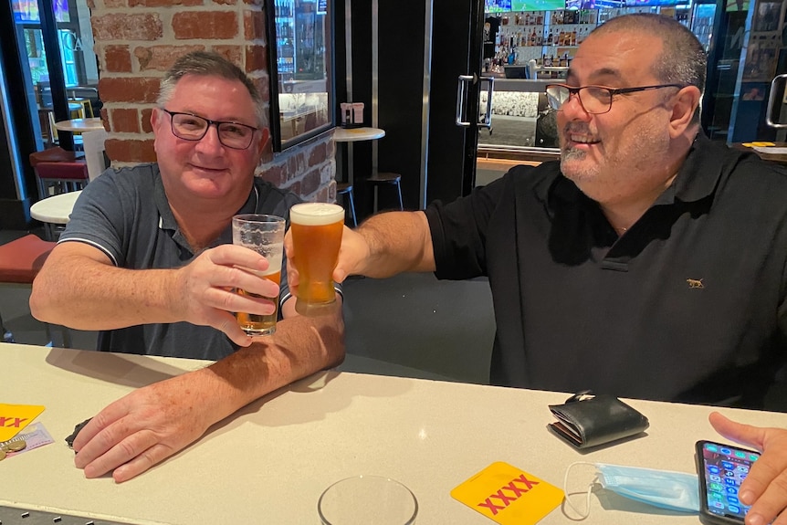 Two men toast with glasses of beer 