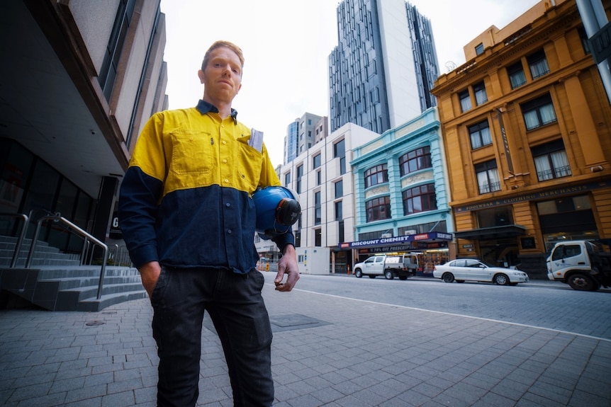 Man holds his hard hat