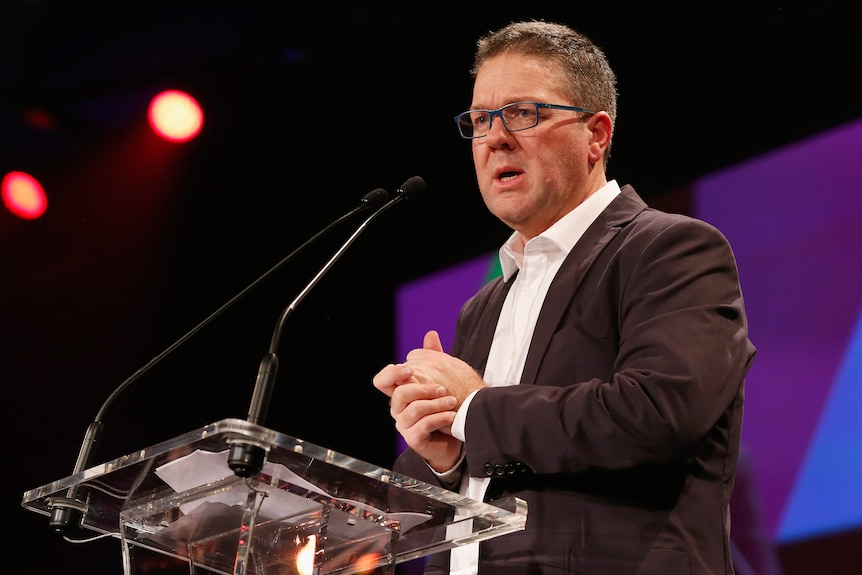 Paul Marsh speaks at a lecturn during the AFL Players' MVP Awards 