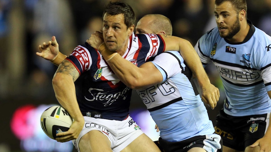 Roosters' Mitchell Pearce offloads the ball against Cronulla in round seven, 2014.