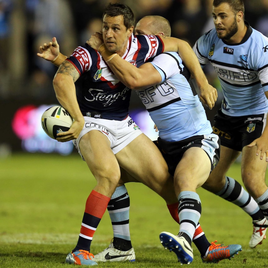 Roosters' Mitchell Pearce offloads the ball against Cronulla in round seven, 2014.
