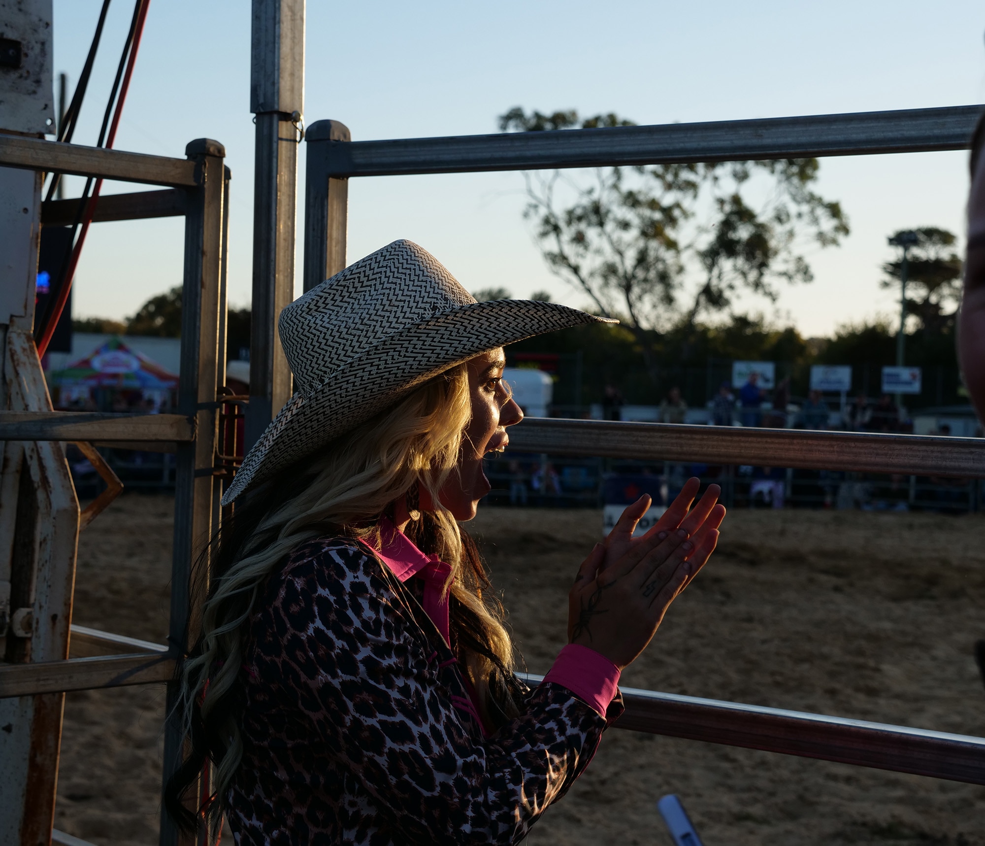 A woman cheering at a rodeo gate