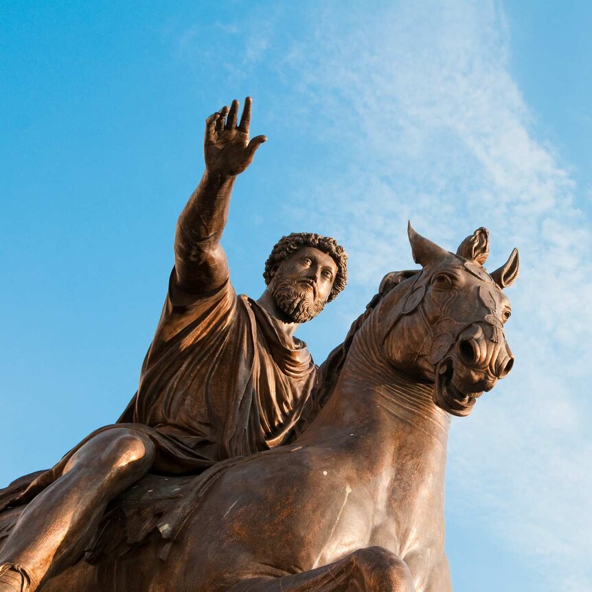 The Equestrian Statue of Marcus Aurelius in Rome, Italy. The bronze statue is photographed against a blue sky.