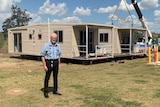 Ewen McPhee stands outside a donga.