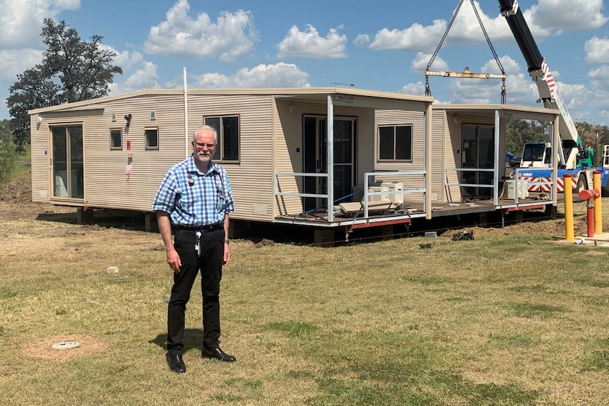 Ewen McPhee stands outside a donga.