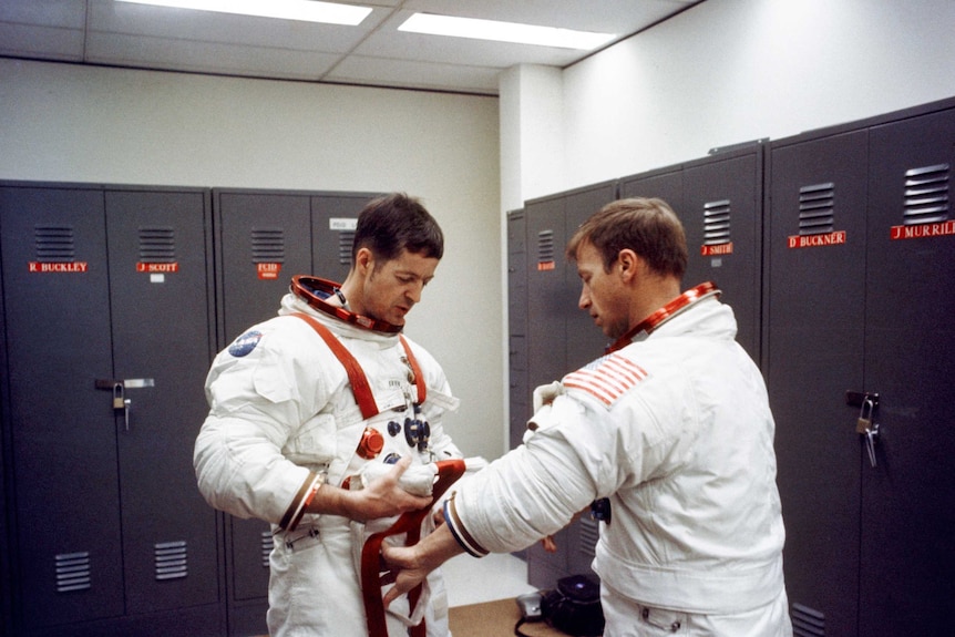 Two astronauts perform final checks before the first manned Skylab mission.