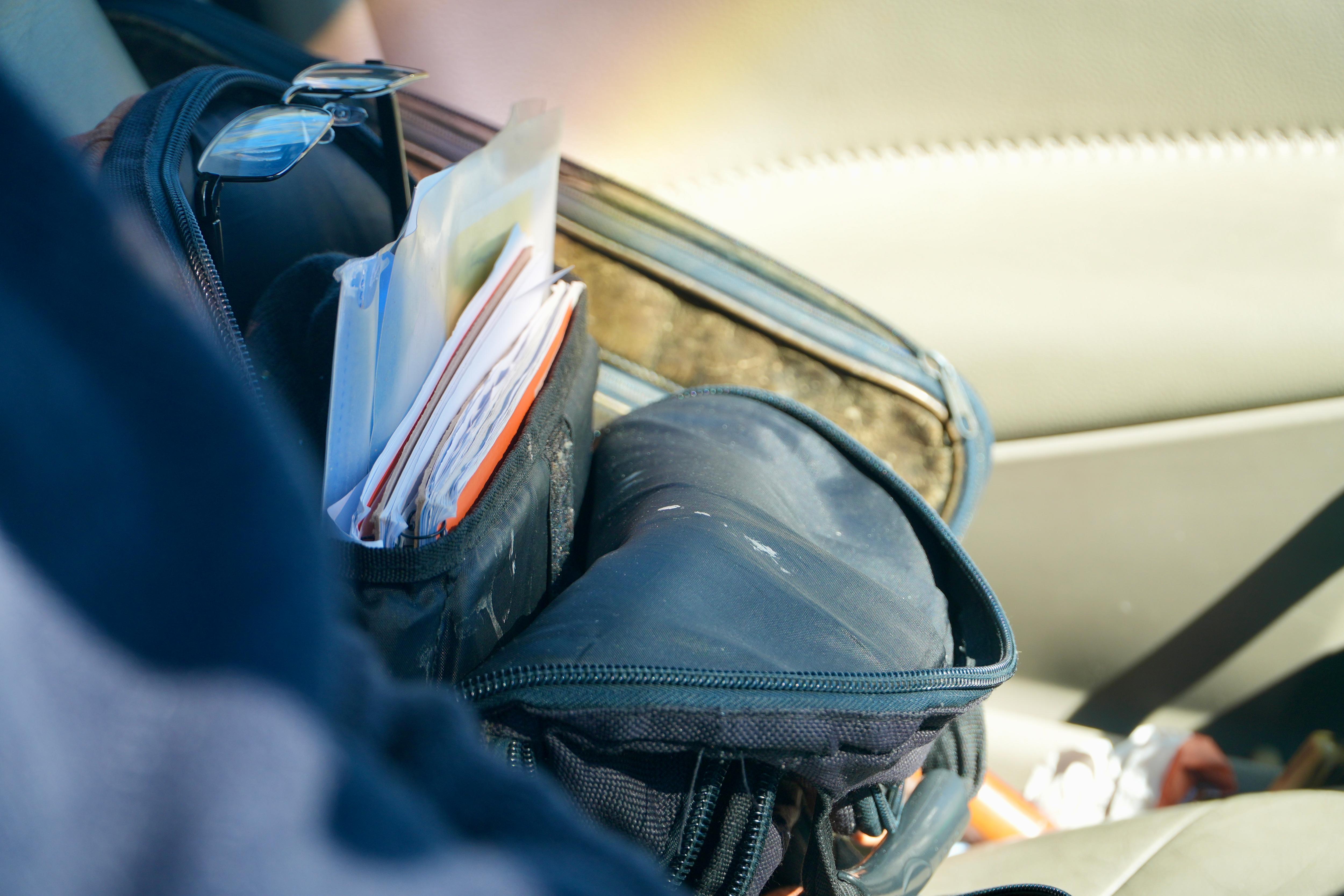 A close-up of documents in a backpack.