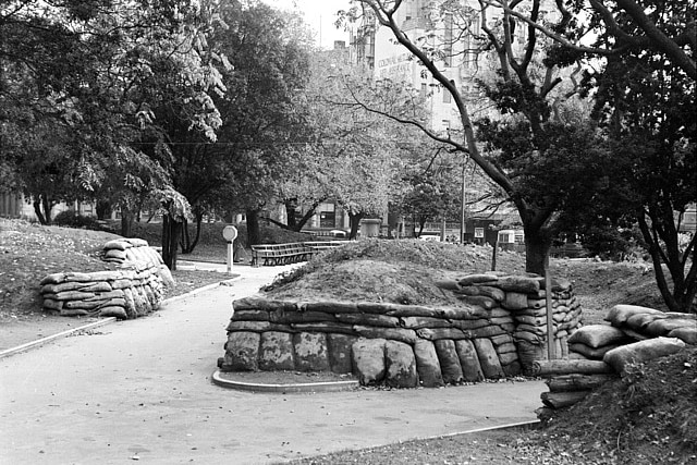 A black and white image of sandbags around a park in the 1940s