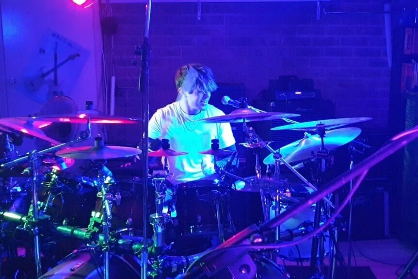 Teenage boy playing the drums. 