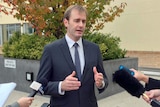 Tasmanian Health Minister Michael Ferguson talks to reporters
