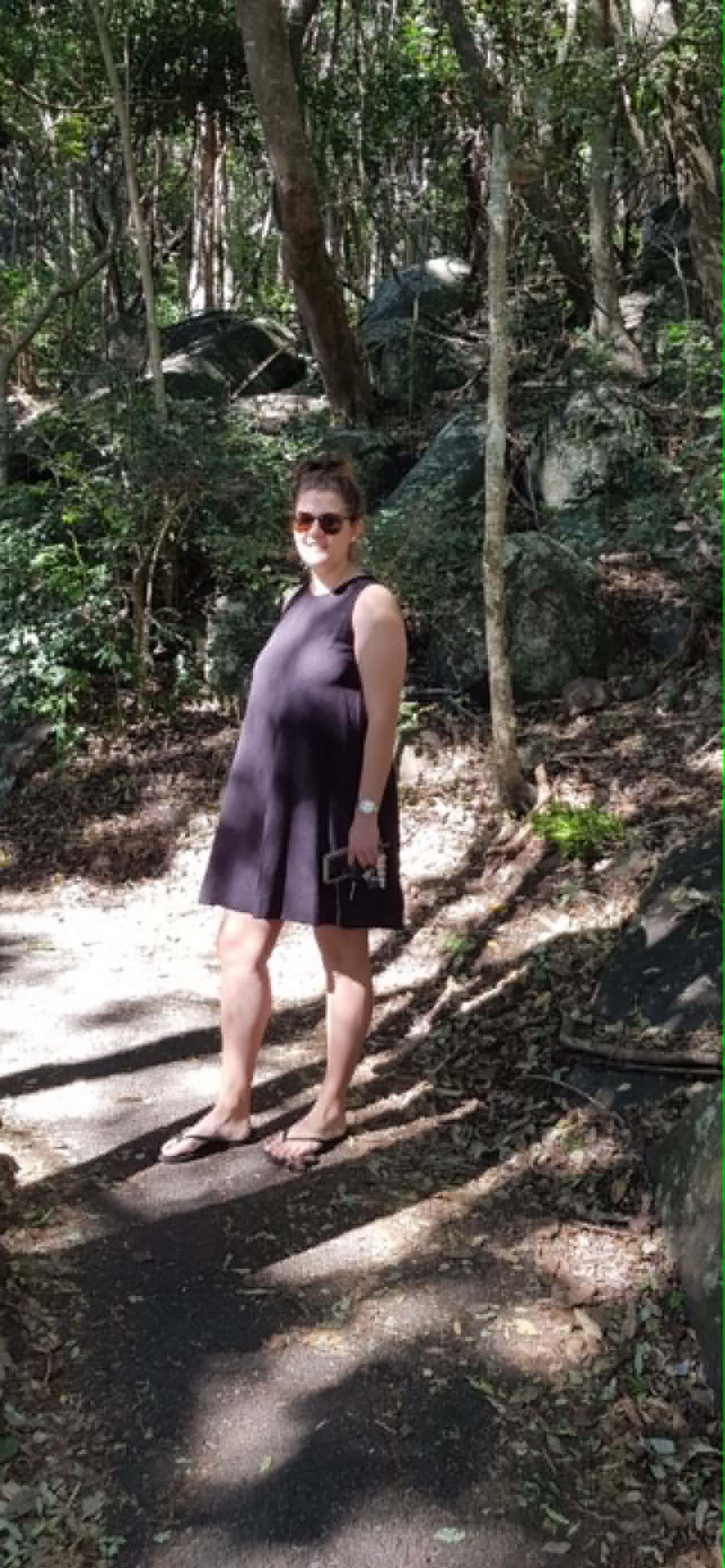 Photo of a woman standing in a bush.