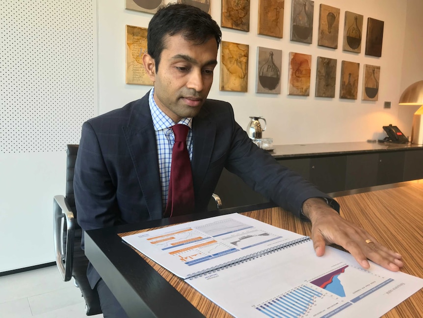 Siddharth Parameswaran, an insurance analyst with JP Morgan, sits looking at a chart.