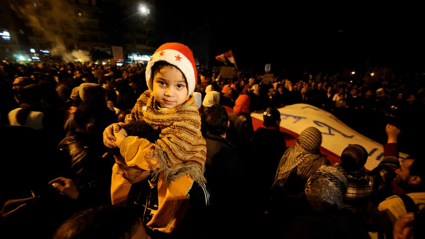 Egyptian boy wearing a Santa hat as thousands gather in Cairo's Tahrir Square during a mass rally against military rulers (AFP)