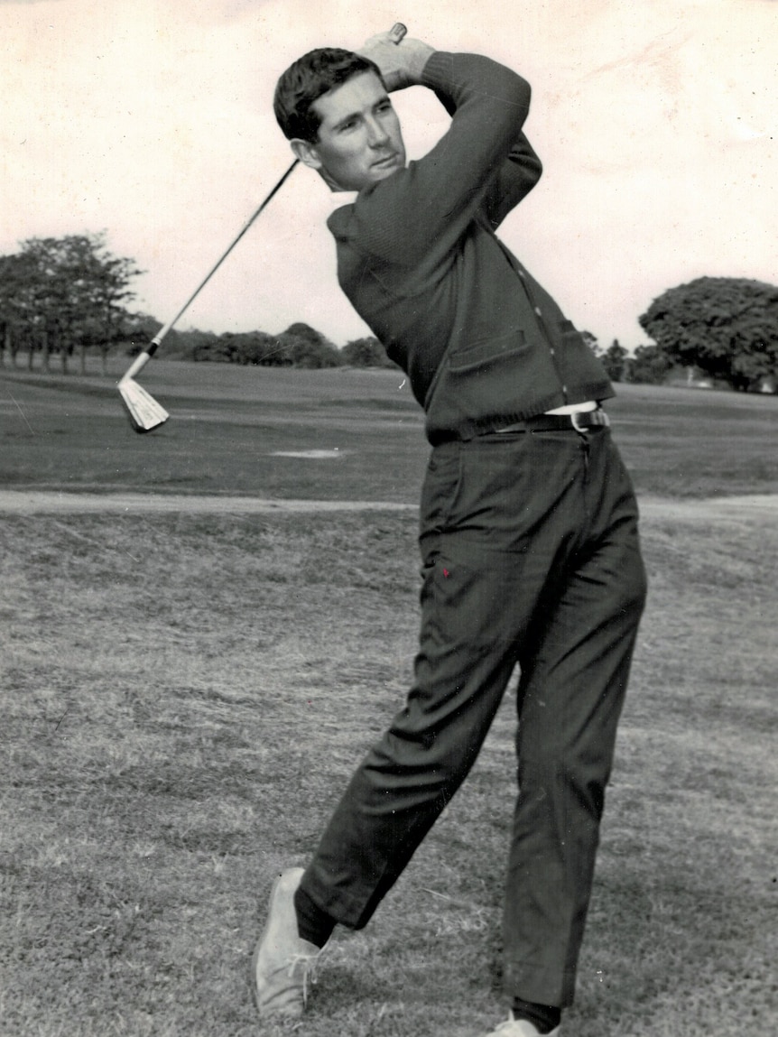 A man swinging a golf club.