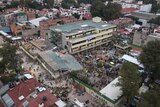 Volunteers and rescue workers search for children trapped inside the Enrique Rebsamen school.