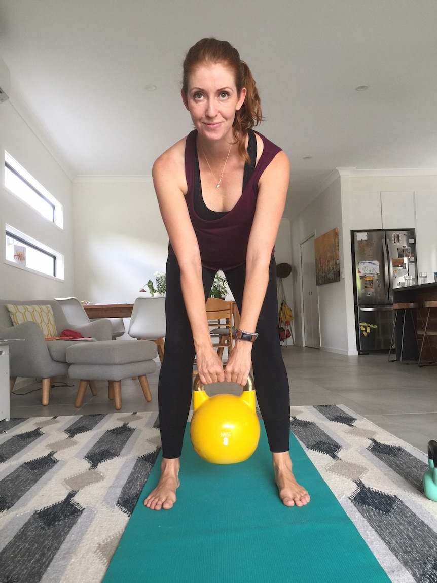 Amy Dawes lifts a kettlebell