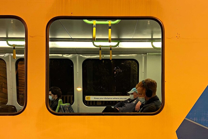 Passengers wearing masks on a Melbourne Metro train.