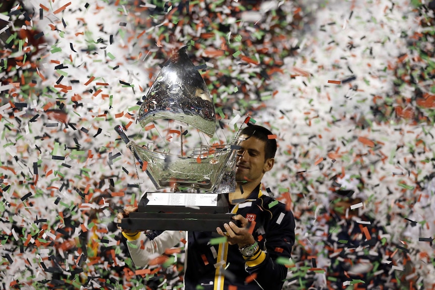 Dubai champ ... Novak Djokovic poses with his trophy after beating Tomas Berdych 7-5, 6-3.