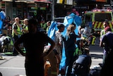Paramedics treat people hit by a car that ploughed through a pedestrian crossing on Flinders Street.