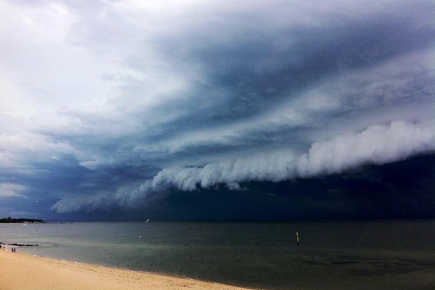 Storm clouds roll in over a beach in the Melbourne suburb of Hampton.