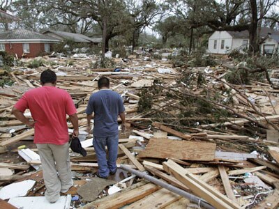 Residents look at the rubble of their apartment block in Biloxi, Mississippi
