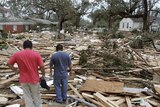Residents look at the rubble of their apartment block in Biloxi, Mississippi