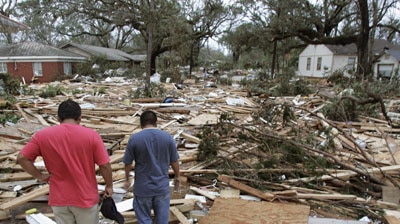 Residents look at the rubble of their apartment block in Biloxi, Mississippi