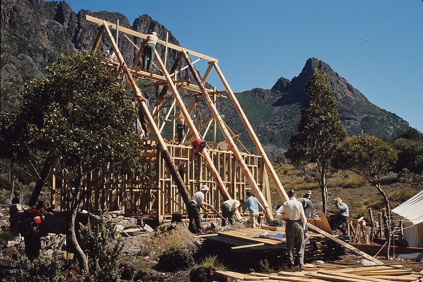 Wooden frame dwelling being built in Tasmanian wilderness.
