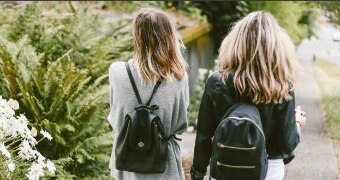 Teenage girls walking along the street.