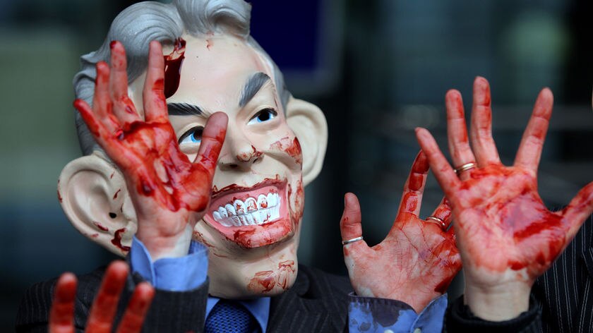 Inquiry opens: a protestor wearing a Tony Blair mask demonstrates in London